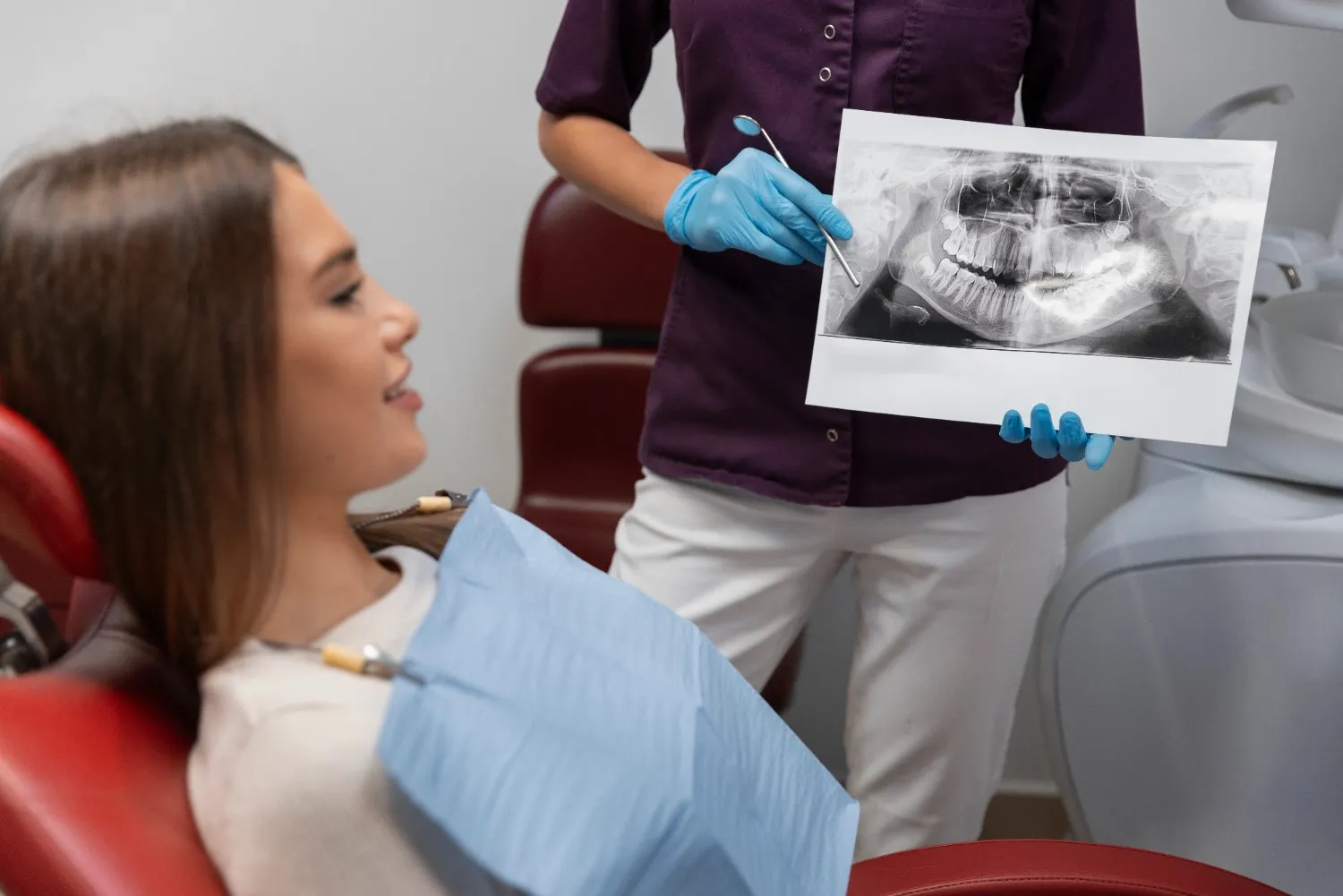 Dental professional showing an X-ray to a patient