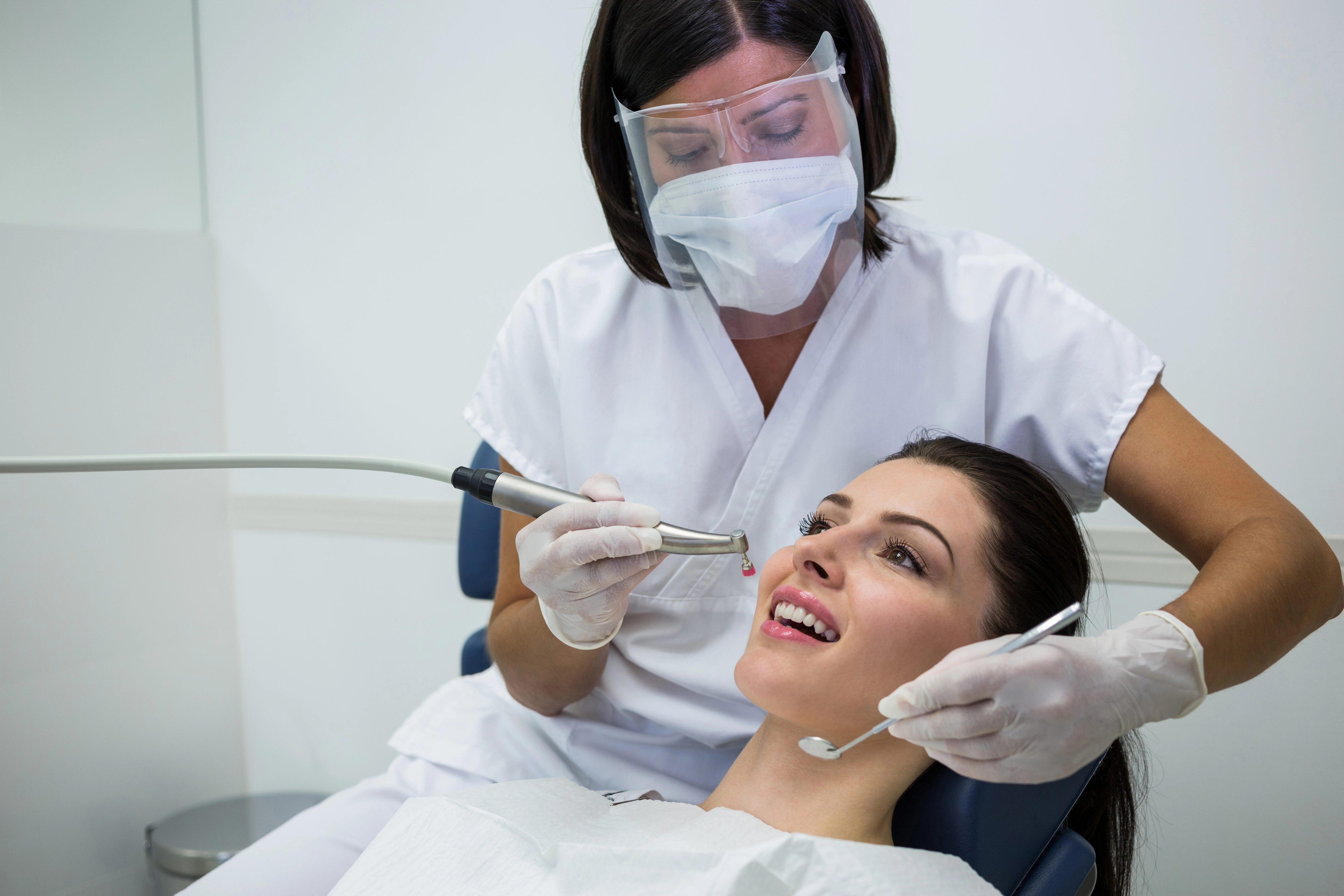 Dentist performing a cosmetic dental procedure on a patient