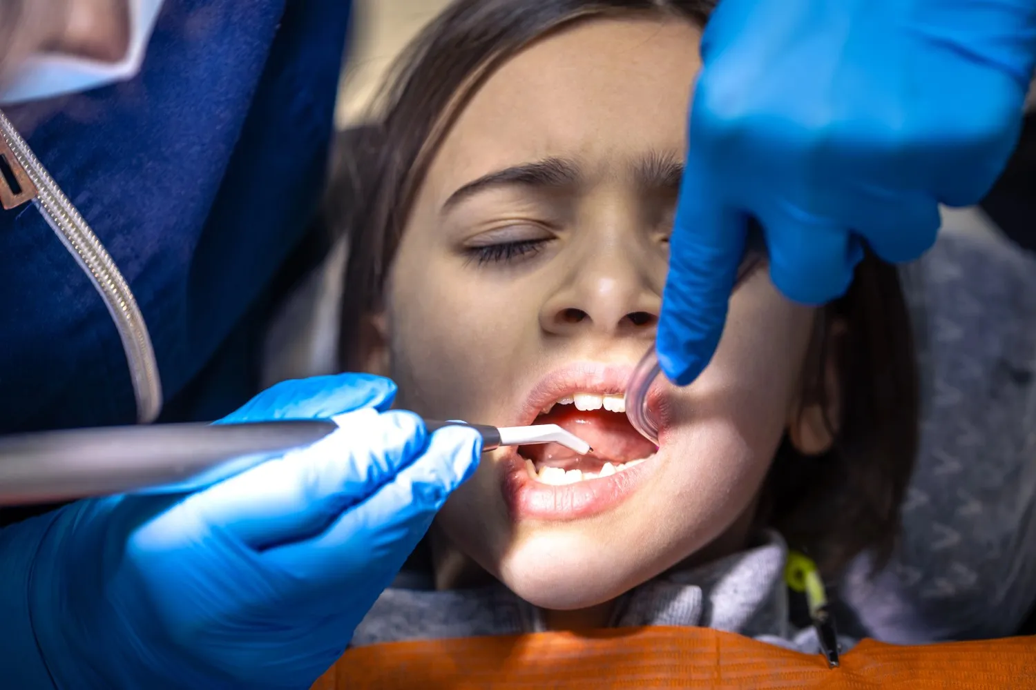 Child undergoing a routine dental exam in a clinic
